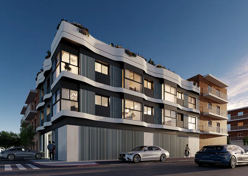 Imagen de un moderno edificio de apartamentos con diseño contemporáneo, destacando líneas curvas y una fachada elegante con ventanas grandes. En la planta baja se observa una entrada principal y vehículos estacionados. El edificio cuenta con balcones decorados con plantas, ofreciendo un atractivo visual y un entorno acogedor.