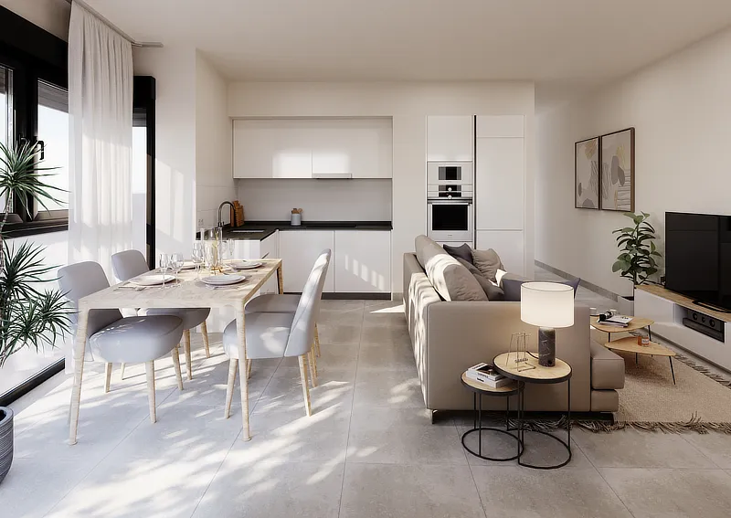 Interior de un apartamento moderno y luminoso con diseño de planta abierta. Se muestra una cocina integrada con mobiliario blanco, un comedor con una mesa de madera clara y sillas grises, y una sala de estar con un cómodo sofá beige. Las grandes ventanas permiten la entrada de abundante luz natural, destacando la amplitud y luminosidad del espacio.