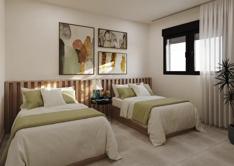 Habitación doble en un apartamento moderno, equipada con dos camas individuales con ropa de cama blanca y cojines verdes. La pared del cabecero está decorada con tres cuadros abstractos, y una lámpara de noche se sitúa entre las camas. La luz natural entra a través de una ventana grande, resaltando la claridad y calidez del espacio.